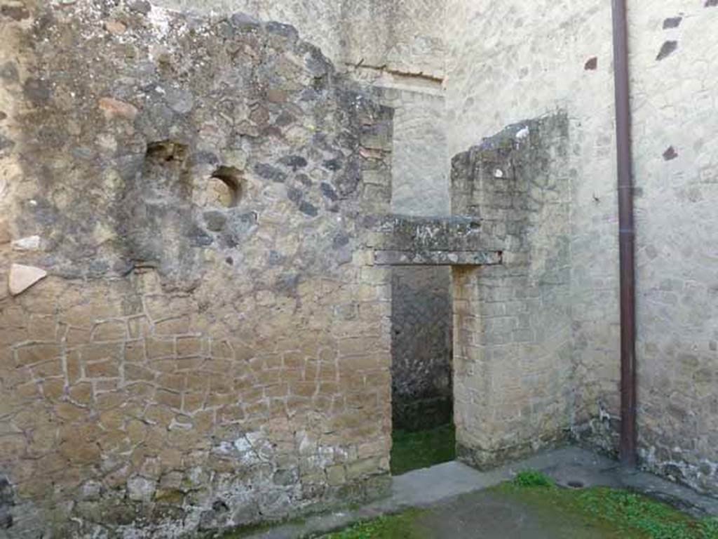Ins. III.9. Herculaneum. May 2010. East wall with doorway into latrine .