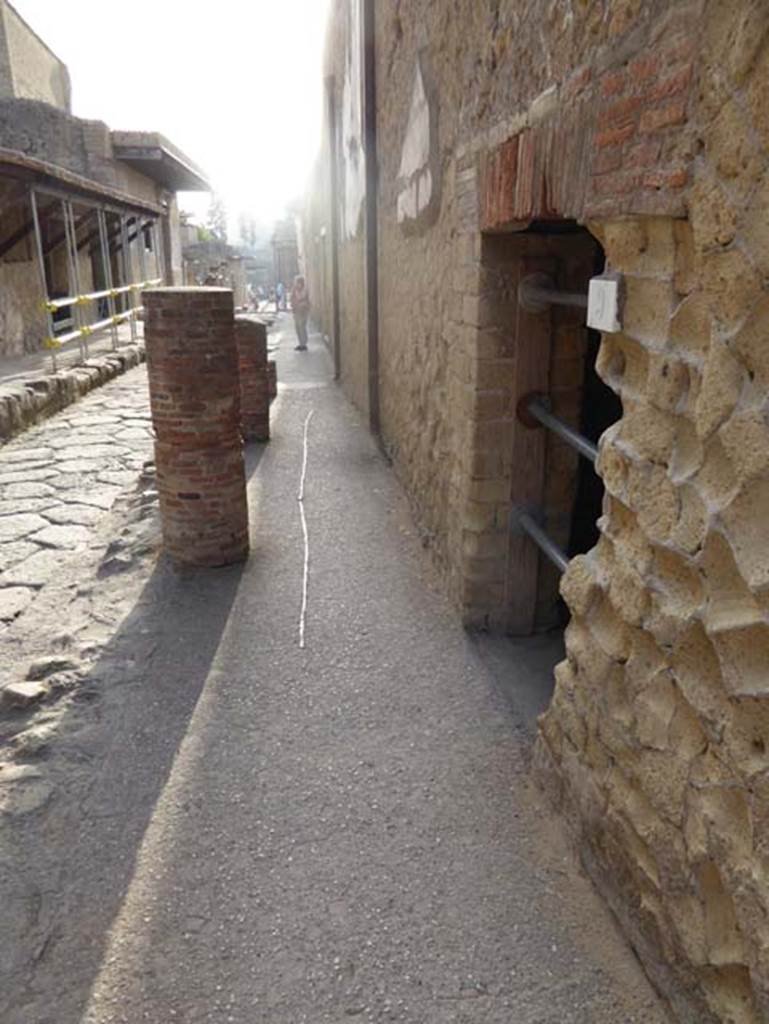 VI.9 Herculaneum, October 2014. Looking south along Cardo IV. Superiore, with doorway on left. Photo courtesy of Michael Binns.
