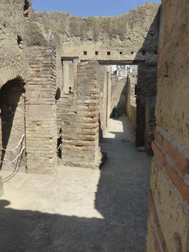VI.10, Herculaneum. June 2014.  Looking west from entrance doorway along corridor at rear of men’s central baths.  Photo courtesy of Michael Binns.
