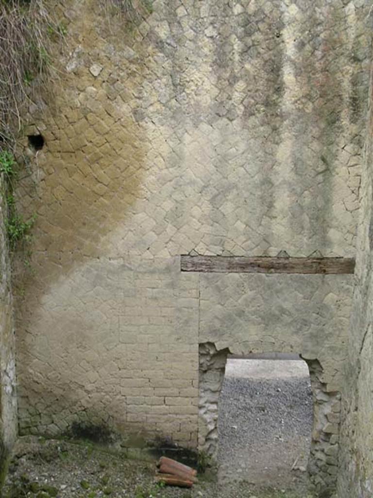 Ins Or II, 15, Herculaneum. May 2004. Rear room, looking towards east wall, and “bricked up” doorway.  
Originally a secondary entrance to/from the level of the Palaestra portico, through a doorway which was then bricked up when this was transformed to a workshop.  Photo courtesy of Nicolas Monteix.
