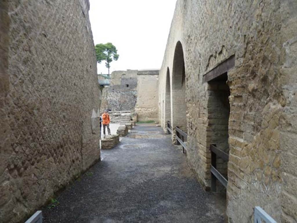 Herculaneum, September 2015. Looking west towards the Sacred Area. The Sacred Area was a large terrace with buildings for worship, which are the chapel of Venus, and the chapel of the four gods. Under this terrace, were six of the twelve arches of the beachfront boatsheds, in which many of the skeletons of the fugitives have been found. 
