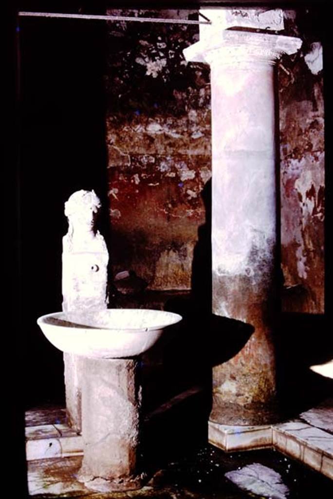 Fountain bust of Apollo, Suburban baths, Herculaneum. 1975. Looking north at fountain bust of Apollo in the atrium.
Photo by Stanley A. Jashemski.   
Source: The Wilhelmina and Stanley A. Jashemski archive in the University of Maryland Library, Special Collections (See collection page) and made available under the Creative Commons Attribution-Non-Commercial License v.4. See Licence and use details.
J75f0723