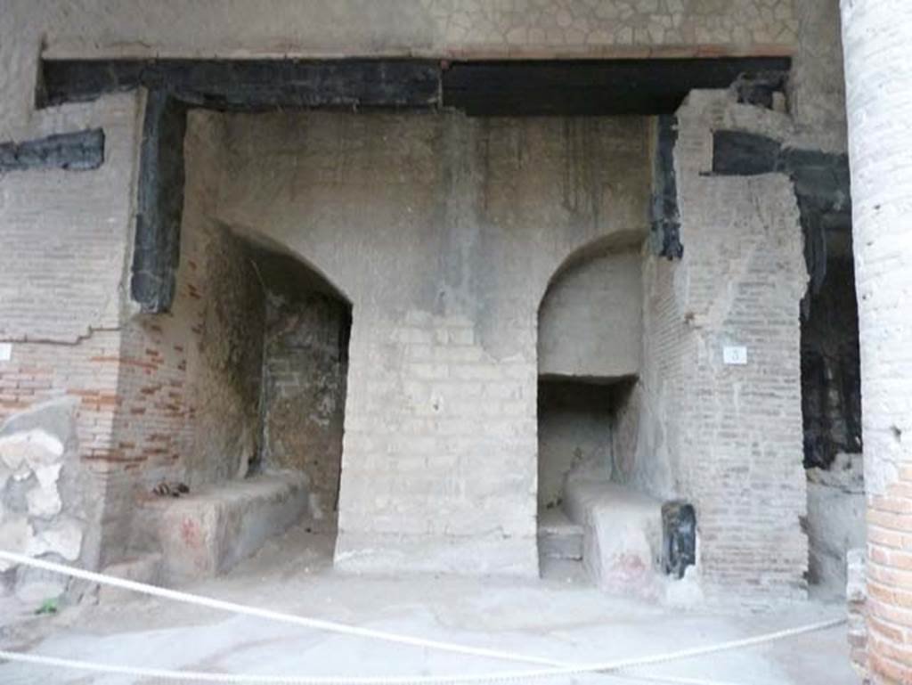 Decumanus Maximus, Herculaneum, September 2015. Building on north side of the Decumanus Maximus, doorways numbered 3.
Wallace-Hadrill wrote that this was the entrance to the grandest house on the Decumanus Maximus which still lies unexcavated under the escarpment.
Its ambitious scale can be seen not only in the impressive brickwork colonnade that runs along its frontage supporting rooms and balconies above, and in the well- preserved shutters on the windows, but also in the breadth of its entrance door, etc.
In the case of the nameless house north of the Decumanus Maximus we can see a wide entrance lobby, with benches on either side, leading to the front door – all that is visible of this are the two wooden door posts on either side.
See Wallace-Hadrill, A. (2011). Herculaneum, Past and Future. London, Frances Lincoln Ltd., (p.238).
