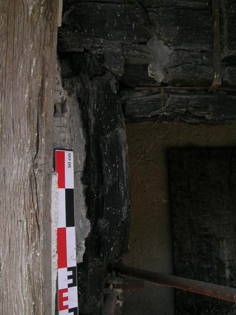 Decumanus Maximus, Herculaneum. May 2006. Detail of carbonised wood from west side of doorway numbered 4.
Photo courtesy of Nicolas Monteix.
