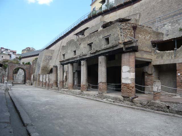 Decumanus Maximus, north side, Herculaneum. March 2014. 
Looking towards doorway 5, on left under colonnade, doorway 6 and 7, and doorway 8 in centre. 
Foto Annette Haug, ERC Grant 681269 DÉCOR.
