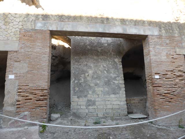 Decumanus Maximus, Herculaneum. August 2013. Looking east from four-sided Arch on Decumanus Maximus. The entrance in the photo below can be seen here on the left, guarded by two ropes across it. Photo courtesy of Buzz Ferebee.

