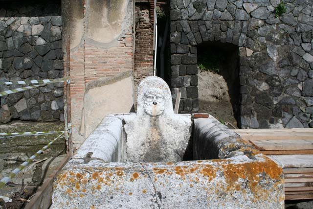 Decumanus Maximus, Herculaneum, May 2001.  Fountain decorated with head of Hercules, from fountain on east end of the Decumanus Maximus.  Photo courtesy of Current Archaeology.

