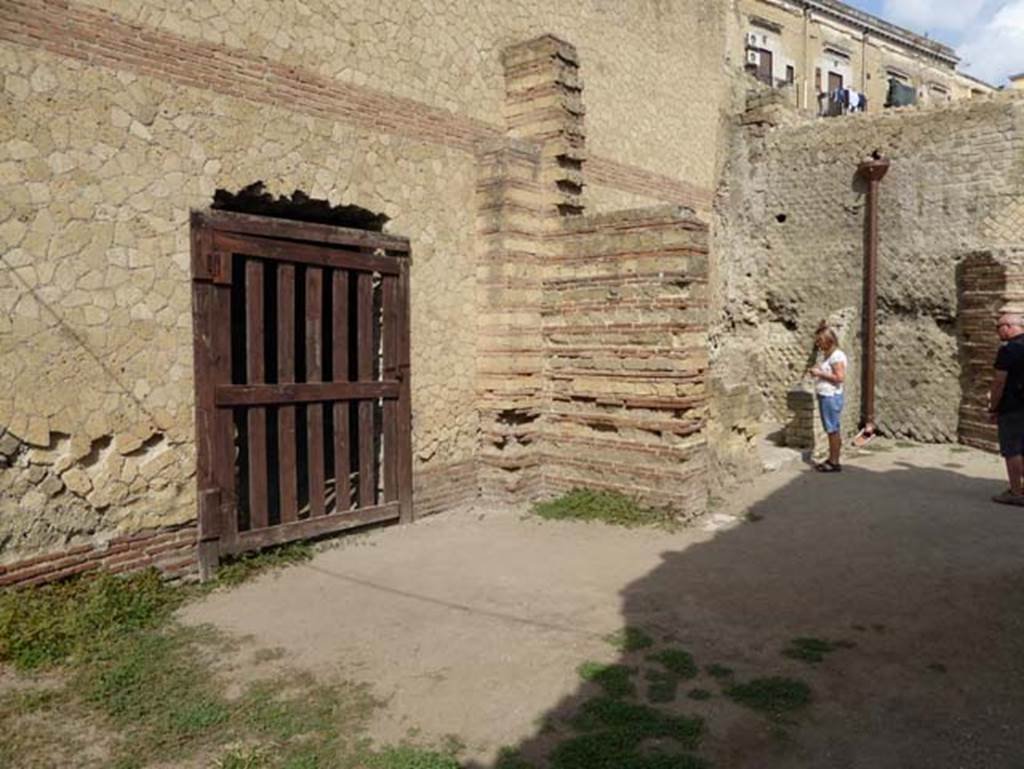 II.1 Herculaneum, October 2014. Rooms on west side of atrium, looking north.
The wooden gate covers a break in the east wall belonging to the large salon of the house at II.2. Photo courtesy of Michael Binns.
