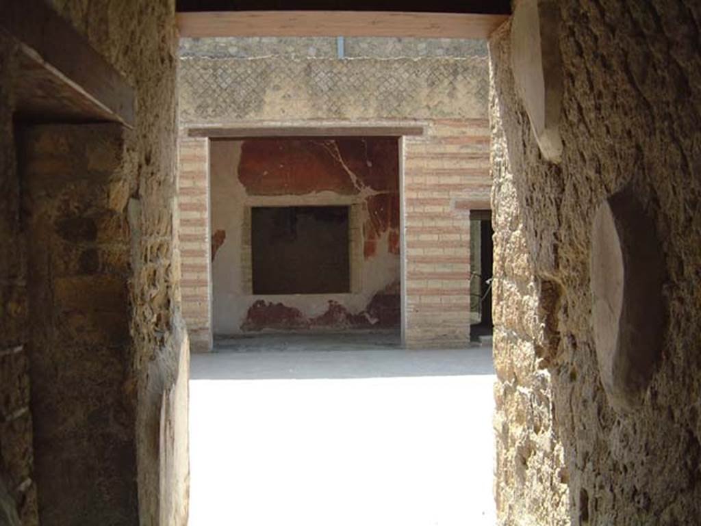 III.3 Herculaneum, May 2001. Looking east from entrance corridor towards atrium.
The doorway to the room on north side of corridor, is on the left.  Photo courtesy of Current Archaeology.
