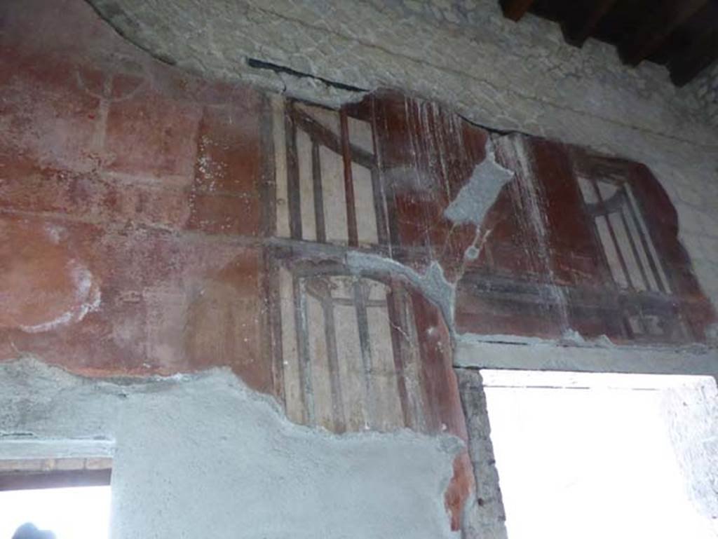 III.3 Herculaneum, April 2016. West wall of triclinium, detail from above doorway to tablinum. Photo courtesy of Michael Binns.
