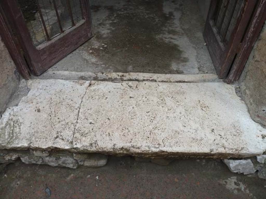 III.16, Herculaneum, May 2018. Threshold to entrance doorway. Photo courtesy of Buzz Ferebee