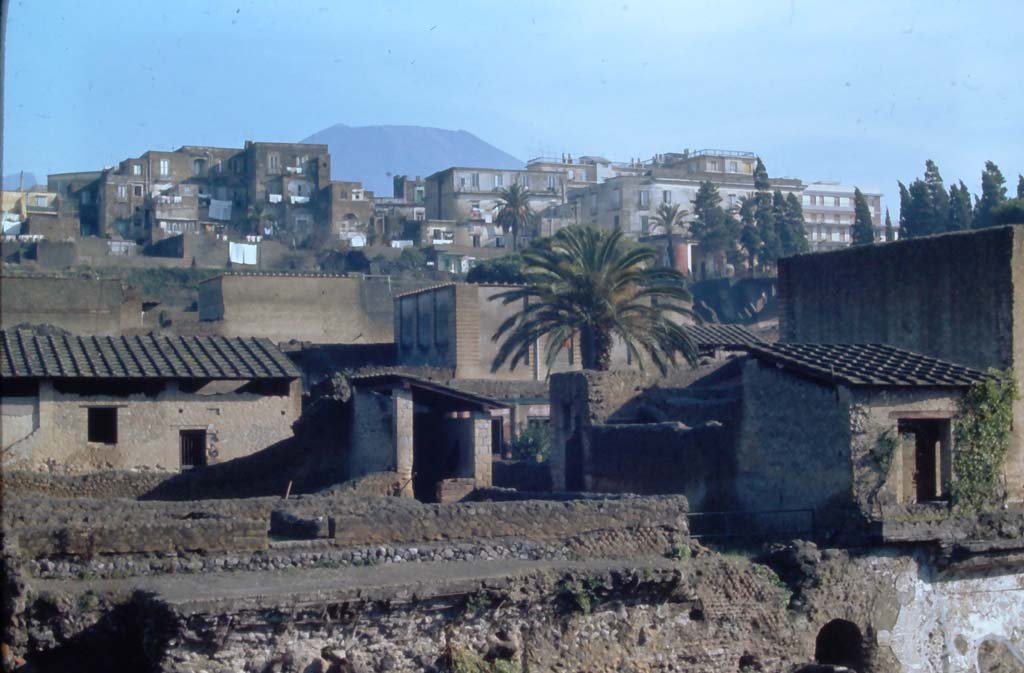 III, 19/18/1, Herculaneum. 4th December 1971. 
Looking north-east from access roadway towards rooms on east side near doorway at III.19, on left and centre.
On the right is part of IV.1/2, House of Mosaic Atrium. 
In the lower right is the south end of the arched gateway, which would have led to the beach from Cardo IV Inferiore.
Photo courtesy of Rick Bauer, from Dr George Fay’s slides collection.
