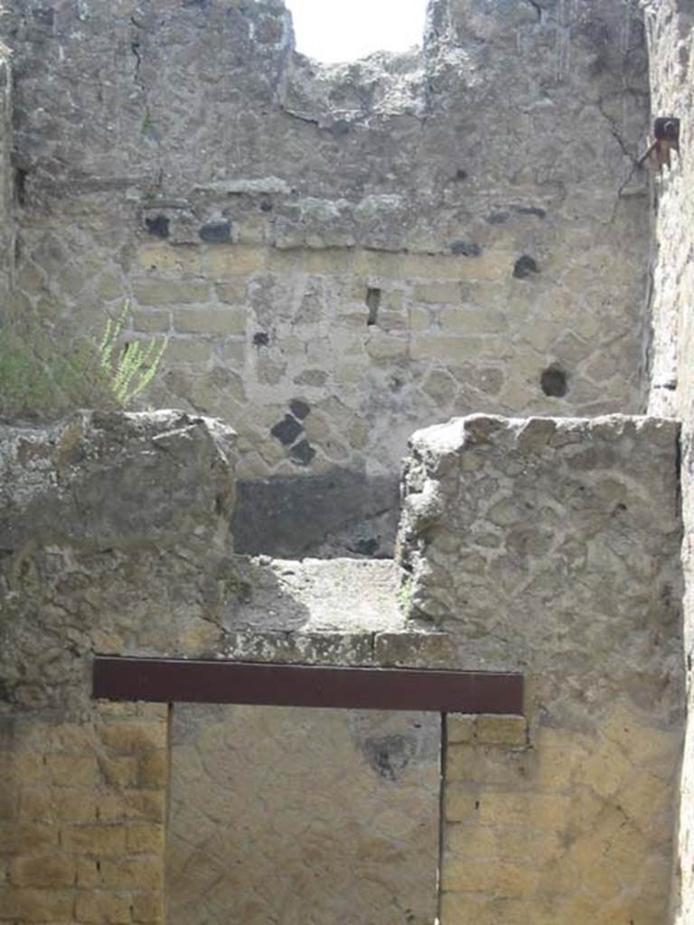 IV.11, Herculaneum, May 2003. 
Looking towards south wall of small cubiculum with doorway to a corridor and small window above it. 
Photo courtesy of Nicolas Monteix.

