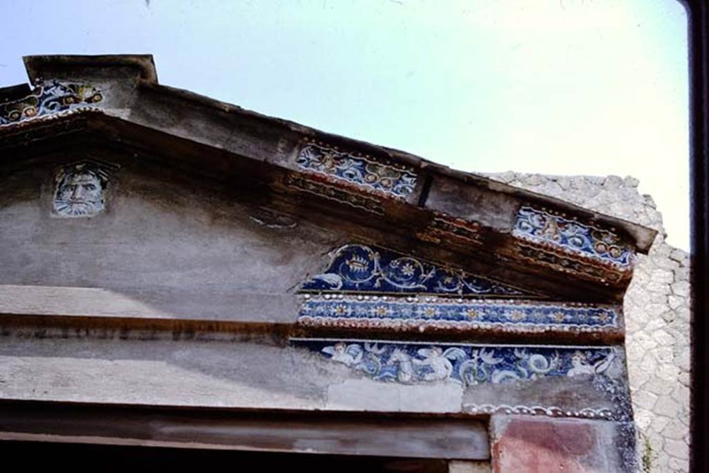 IV.21, Herculaneum. 1964.  
Detail from east end of the glass-paste mosaic portal, with the head of Oceanus, and frieze of cupids on seahorses.
Photo by Stanley A. Jashemski.
Source: The Wilhelmina and Stanley A. Jashemski archive in the University of Maryland Library, Special Collections (See collection page) and made available under the Creative Commons Attribution-Non-Commercial License v.4. See Licence and use details.
J64f1381
