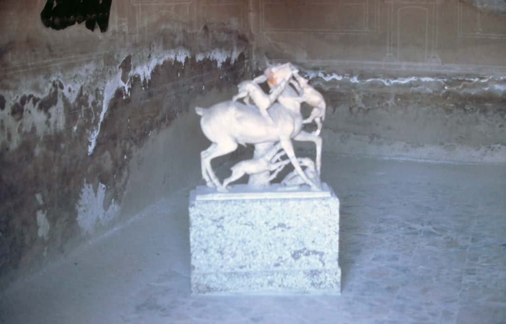 IV.21, Herculaneum. 7th August 1976. Second statue of deer being attacked by hounds, on display in a room of the house.
Photo courtesy of Rick Bauer, from Dr George Fay’s slides collection.


