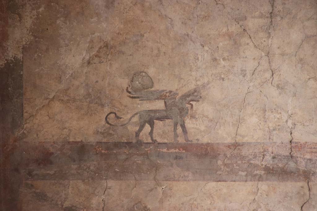 IV.21, Herculaneum. October 2020. 
Room 24, detail of painted decorations (Sphynx) from upper west wall of atrium at south end. Photo courtesy of Klaus Heese. 
