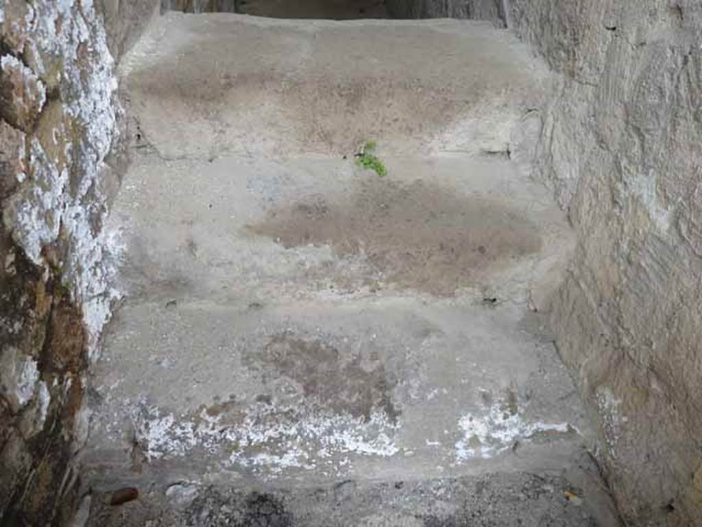 V.2, Herculaneum. May 2010. Base of steps to upper floor in doorway.  