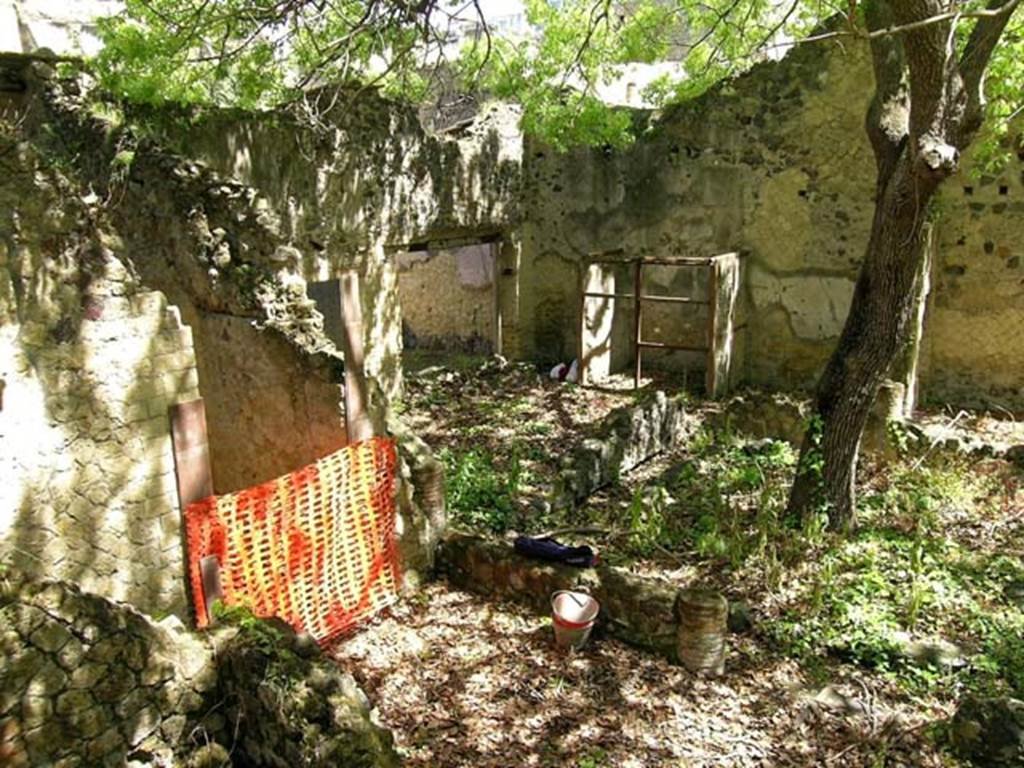 V.4, Herculaneum, May 2004. Garden area M, looking north-west across garden from south side (west end). The corridor to V.3 is behind the red/yellow plastic.  Photo courtesy of Nicolas Monteix.

