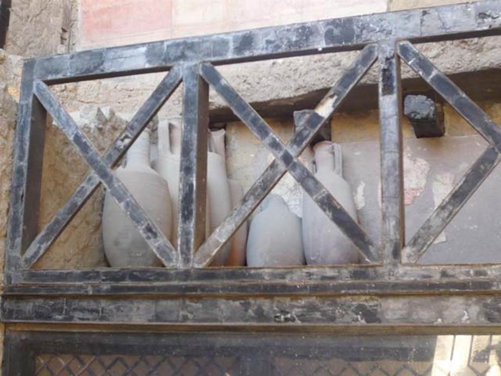 V 6, Herculaneum, August 2013. Detail of amphorae from upper floor at north end of east side of shop. Photo courtesy of Buzz Ferebee. 
