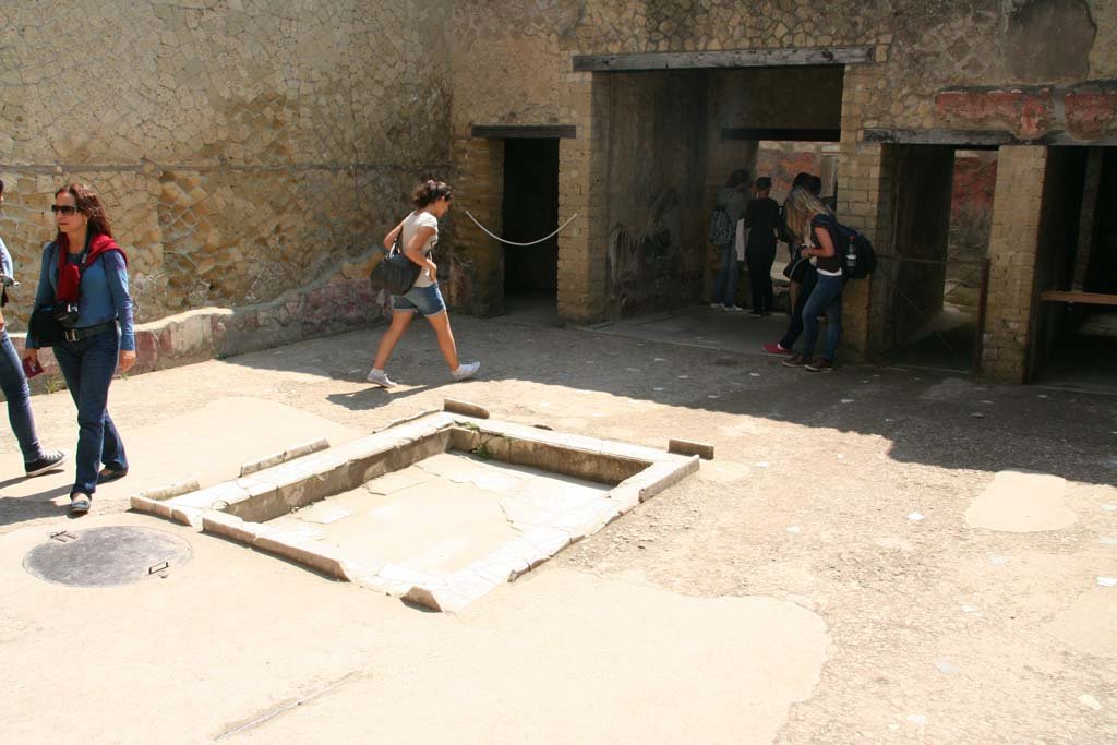 V.7 Herculaneum, April 2011.  
Looking east across impluvium in atrium to small room in north-east corner, centre left, next to tablinum, centre right.
Photo courtesy of Klaus Heese. 

