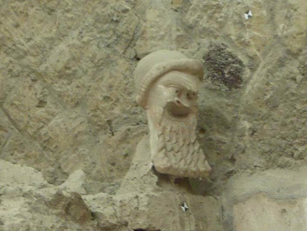 V.7, Herculaneum. August 2013. Detail of mask on north wall. Photo courtesy of Buzz Ferebee.