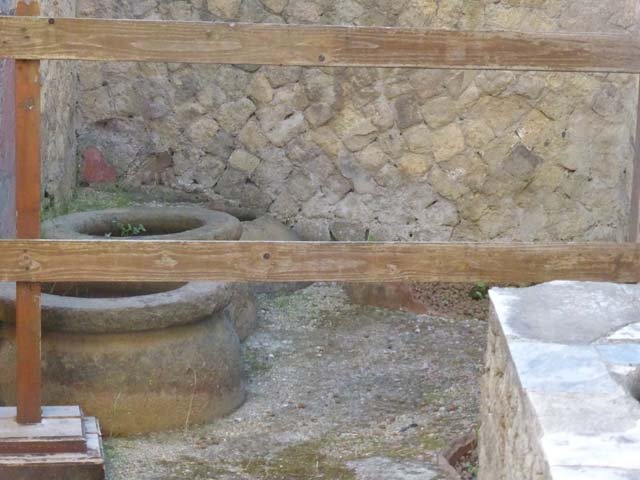 V.10, Herculaneum, September 2015. Large pots, dolia, set into the ground in rear room, to preserve cereals and dried vegetables.