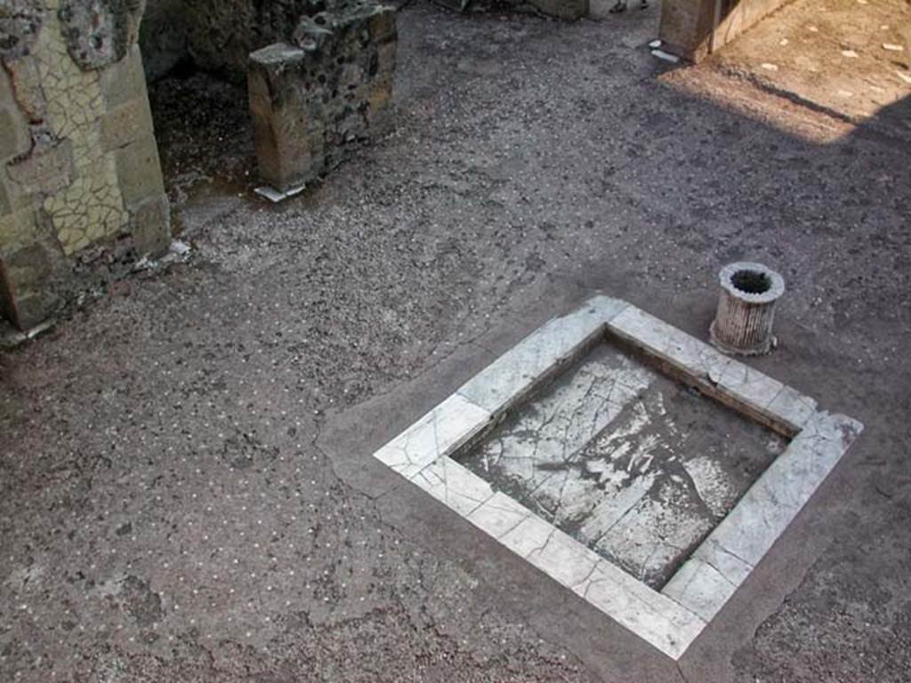 VI.13 Herculaneum, June 2014. Looking south across impluvium in atrium. 
On the right, the west ala can just be seen – a kitchen, set up in place of the original ala.  Photo courtesy of Michael Binns.
