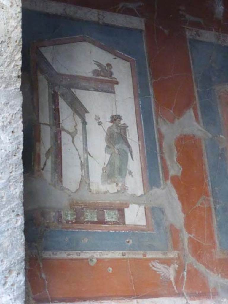 VI.16 Herculaneum. September 2015. Upper painting at north end of east wall showing a statue of a maenad holding a cornucopia. 
