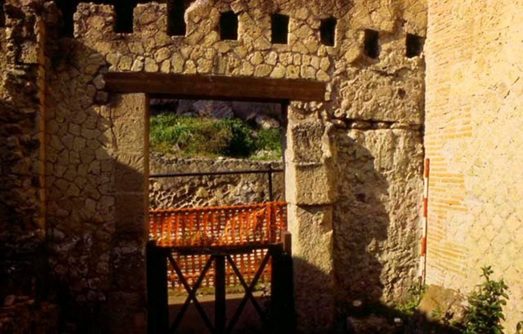 VI.25, Herculaneum. Not dated. Looking towards west wall of shop-room. Photo courtesy of Nicolas Monteix.
On the right of the doorway looks like a bloicked doorway that would have led to the stairs to the upper floor.

