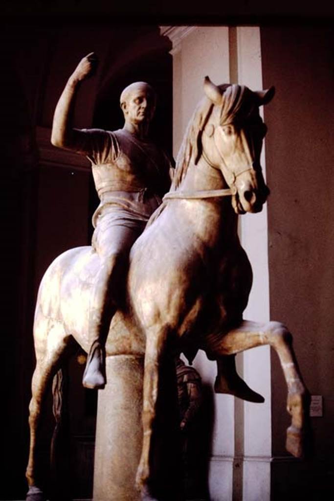 VII.16 Herculaneum. 1978. Statue of M. Nonius Balbus, 
Now in Naples Archaeological Museum. Inventory number 6211.
This statue is often identified as the father of M. Nonius Balbus.
The two statues on horseback may be of the same M. Nonius Balbus, but portraying different stages in his life, see Cooley, above, writing below first photo – 
See Cooley, A. and M.G.L., 2014. Pompeii and Herculaneum: A Sourcebook. London: Routledge, (p.186-191, F94-105) 
Photo by Stanley A. Jashemski.   
Source: The Wilhelmina and Stanley A. Jashemski archive in the University of Maryland Library, Special Collections (See collection page) and made available under the Creative Commons Attribution-Non Commercial License v.4. See Licence and use details.
J78f0441
According to Wallace-Hadrill, this statue is often thought of as being from the so-called Basilica but in fact was from outside the theatre.
See Wallace-Hadrill, A. 2011. Herculaneum, Past and Future. London, Frances Lincoln Ltd, (p.192).

According to the information board in the Palazzo Reale at Portici in 2015, the two statues are believed to portray the same individual, being honoured respectively, by the towns of Nuceria and Herculaneum.
