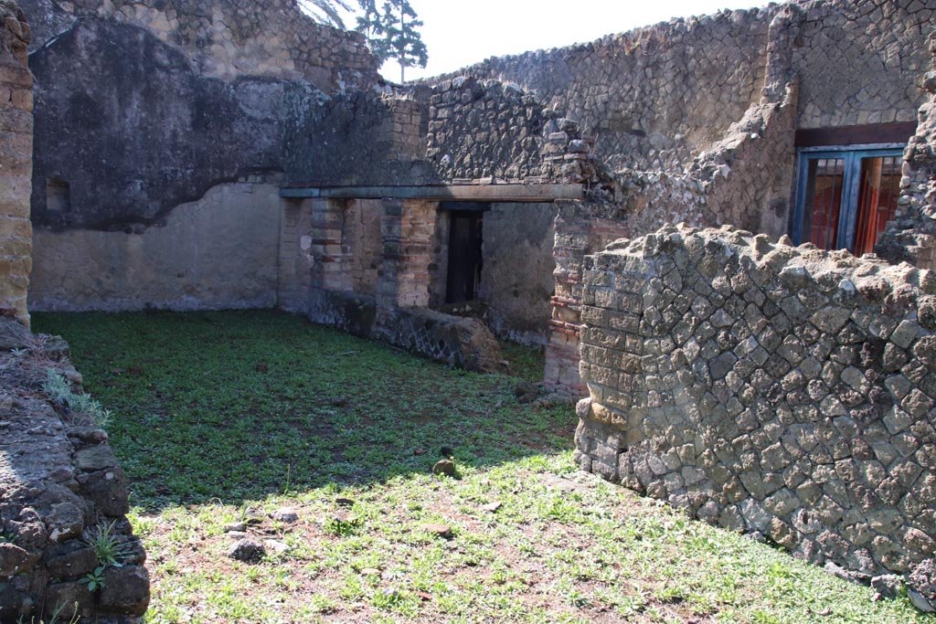 Ins. Orientalis I.3, Herculaneum, October 2022. 
Looking south-east towards area from two doorways in north wall of atrium of Ins.Or.I.2. Photo courtesy of Klaus Heese.
