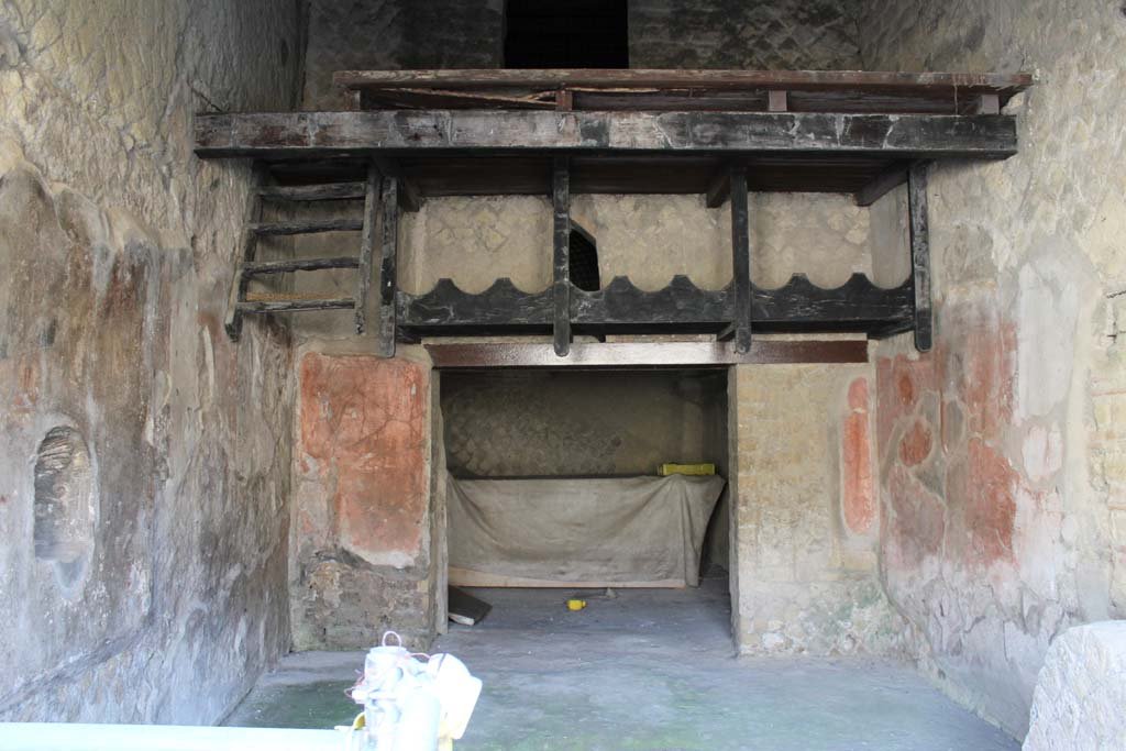 Ins. Orientalis II.9, Herculaneum. March 2014. Looking east to details of carbonised wooden storage and remains of ladder.  
Foto Annette Haug, ERC Grant 681269 DÉCOR
According to Deiss, “The amphorae of wine were laid lengthwise on a supporting wooden scaffold, cut to fit their shape.
They were reached by a ship’s ladder of wood, which now dangles in space, carbonised.”
“One amphora is marked with an inscription, quickly brushed in red: L. R. ANTIGONI”.
See Deiss, J.J. 1968. Herculaneum: a city returns to the sun. UK, The History Book Club, (p.106).

