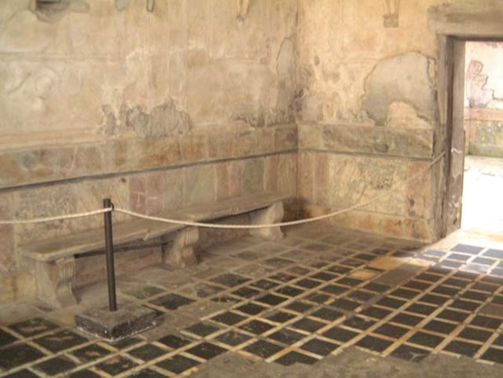 Suburban Baths, Herculaneum, May 2001. Looking across flooring in tepidarium towards doorway to frigidarium, on right. Photo courtesy of Current Archaeology.
The zoccolo on the walls of the tepidarium was formed from slabs of marble.
A bench was set against all three walls, this one against the west wall.  

