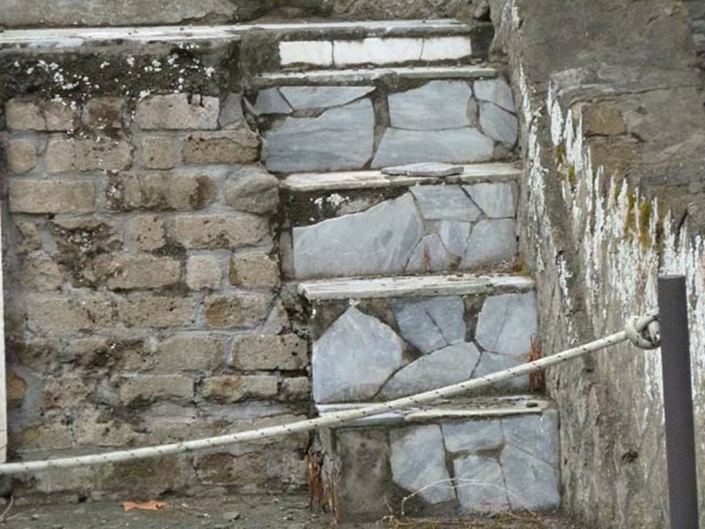 Herculaneum, September 2015. Sacred Area terrace, steps on east end of the shrine of the four gods. Originally it is thought the shrine would have had steps at either end of the podium, but at the west end the podium had been damaged by a Bourbon tunnel.
