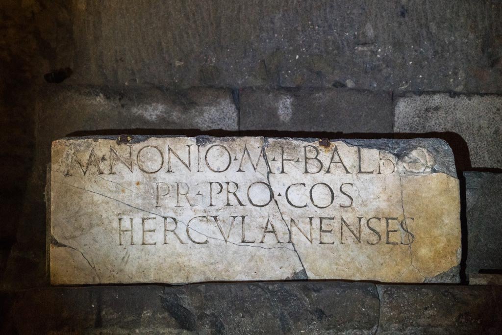 Herculaneum Theatre. October 2023. Copy of inscription to M. Nonio M F Balbo, in situ underground. Photo courtesy of Johannes Eber. 