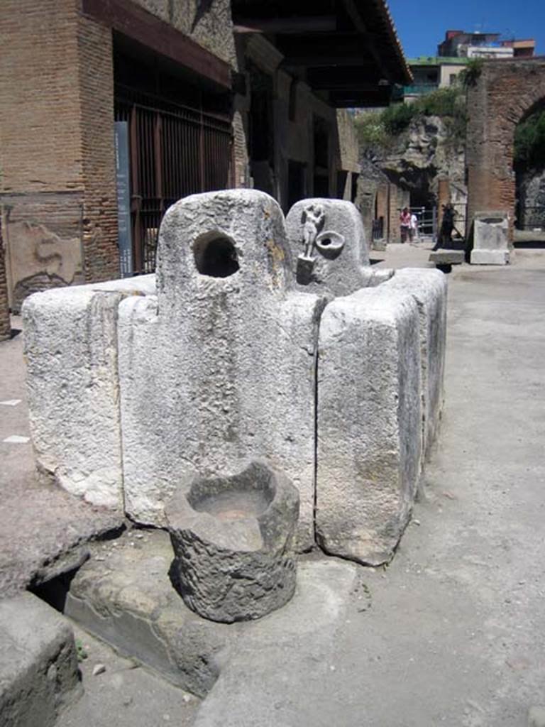 Decumanus Maximus, south side, Herculaneum. June 2011. Diversion in drainage channel by the fountain of Venus. 
This presumably connects with the drain in the end of Cardo IV.
Photo courtesy of Sera Baker.

